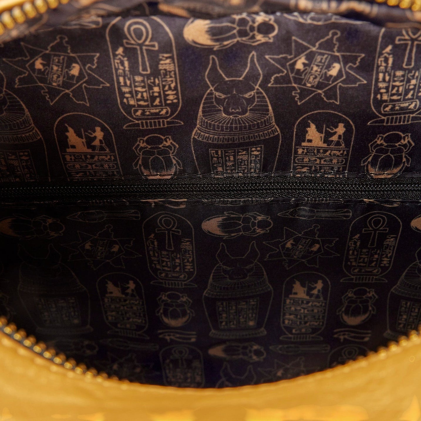 Cards & Comics Connection Loungefly The Mummy backpack interior featuring black lining with gold Egyptian symbols
